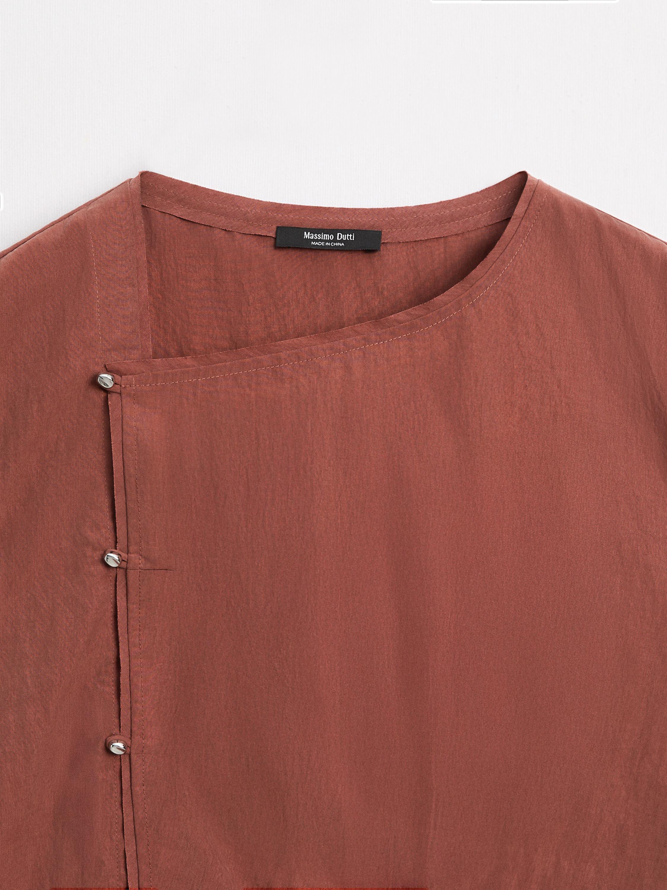 Blouse with silver button fastening on the side